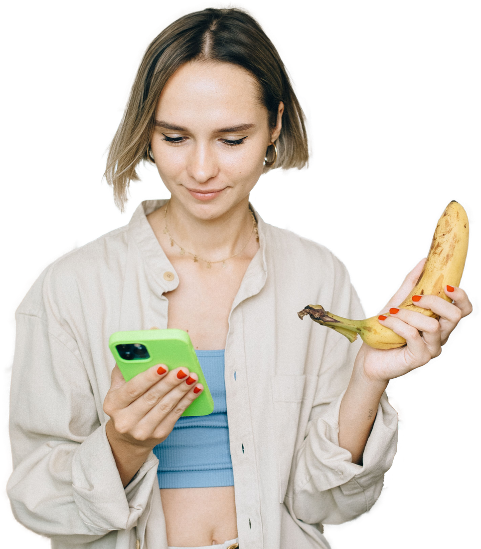 Person checking their phone while holding fresh fruit